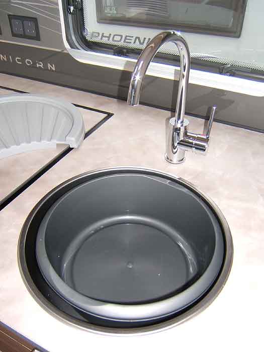 The stainles steel kitchen sink with swan neck mixer tap.